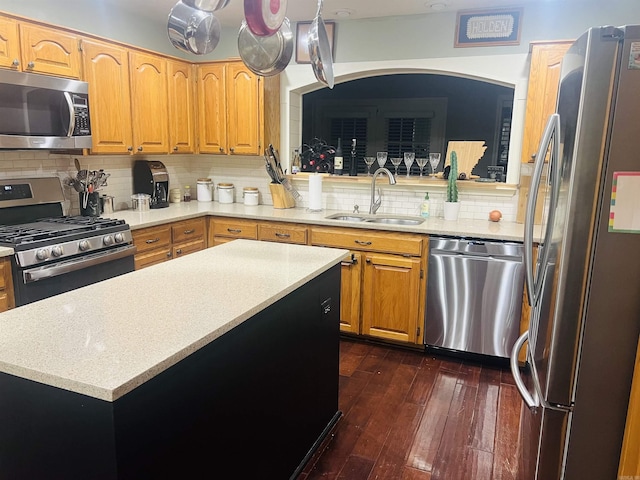 kitchen featuring sink, hanging light fixtures, stainless steel appliances, tasteful backsplash, and dark hardwood / wood-style flooring