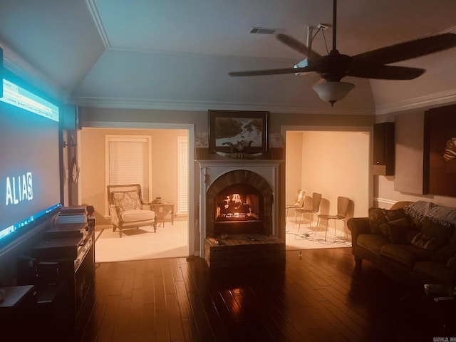 interior space featuring dark hardwood / wood-style floors, lofted ceiling, crown molding, and a brick fireplace