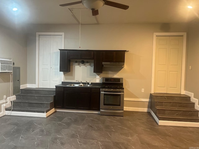 kitchen featuring sink, an AC wall unit, ceiling fan, and stainless steel range with gas stovetop