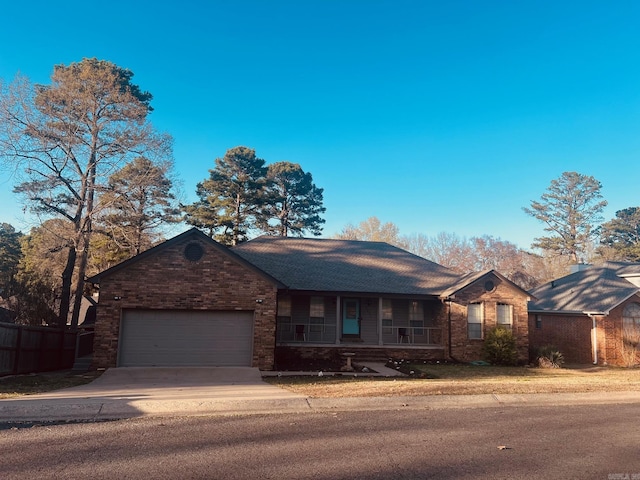 ranch-style home with a porch and a garage