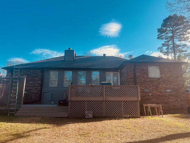 rear view of house featuring a yard and a wooden deck