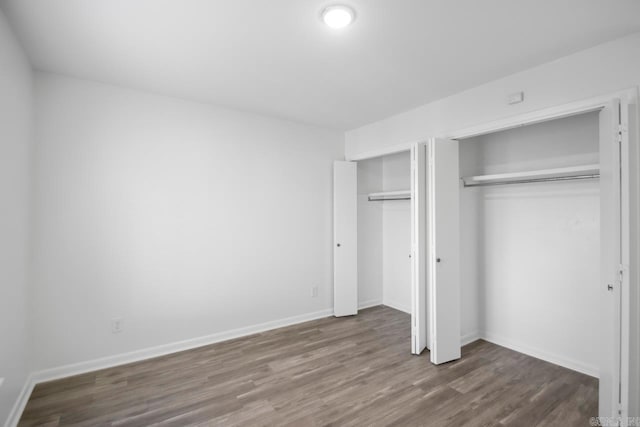 unfurnished bedroom with a closet and hardwood / wood-style floors