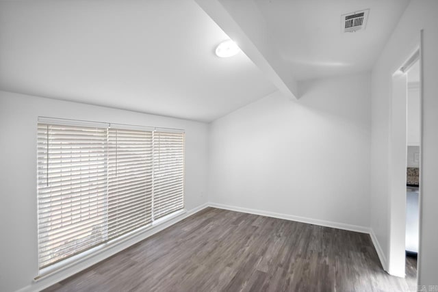 spare room featuring vaulted ceiling with beams and dark hardwood / wood-style flooring