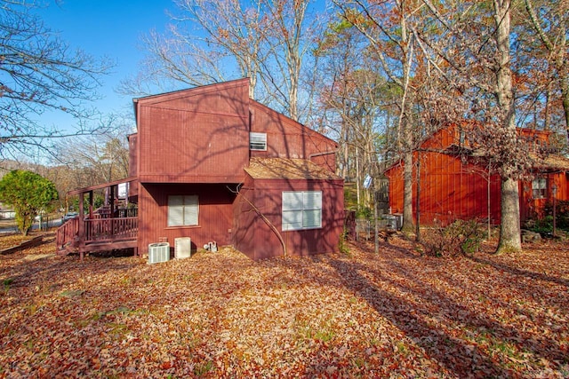 view of side of home with central air condition unit