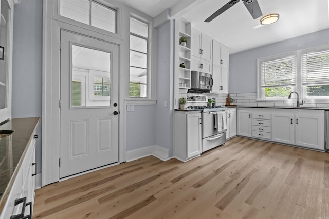 kitchen featuring white cabinetry, sink, appliances with stainless steel finishes, and light hardwood / wood-style flooring