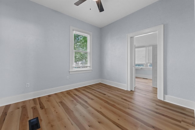 empty room featuring ceiling fan and light hardwood / wood-style flooring