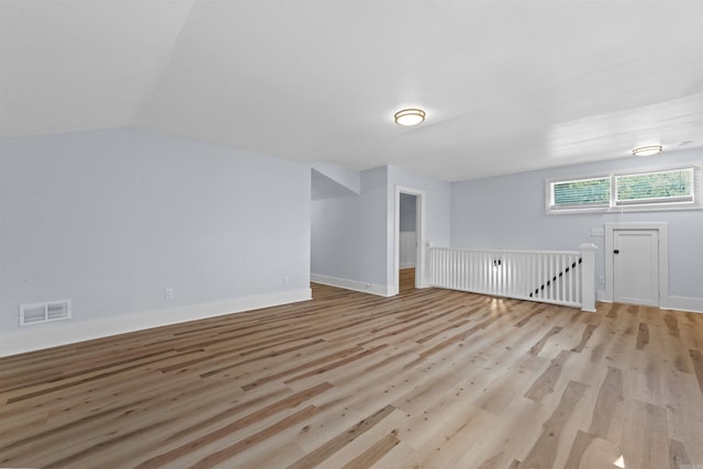 bonus room featuring light hardwood / wood-style flooring and vaulted ceiling