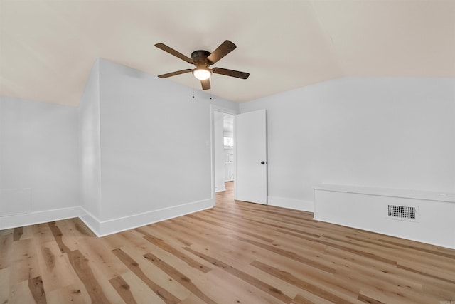 unfurnished room with light hardwood / wood-style floors, vaulted ceiling, and ceiling fan