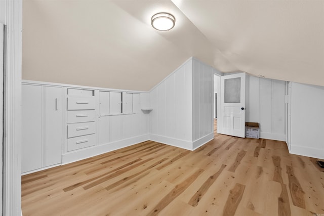 bonus room with light hardwood / wood-style flooring and vaulted ceiling