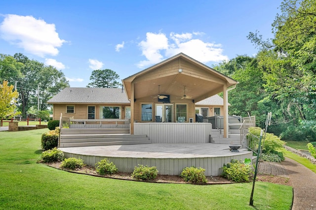 back of house featuring ceiling fan, a yard, and a wooden deck