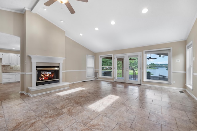 unfurnished living room with ceiling fan, crown molding, and high vaulted ceiling