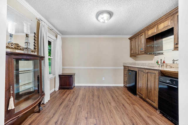 kitchen featuring black dishwasher, a textured ceiling, dark hardwood / wood-style floors, and ornamental molding