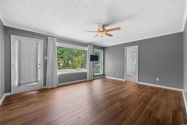 spare room featuring ceiling fan, dark hardwood / wood-style flooring, a textured ceiling, and crown molding