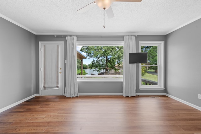 unfurnished room with ceiling fan, hardwood / wood-style floors, and a textured ceiling