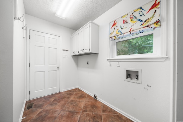 washroom with cabinets, washer hookup, electric dryer hookup, hookup for a gas dryer, and a textured ceiling