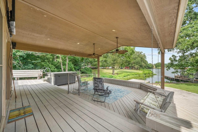 wooden terrace featuring a water view and ceiling fan