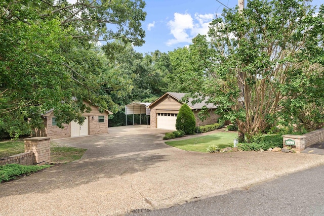 view of front of property with a carport, an outdoor structure, and a front yard