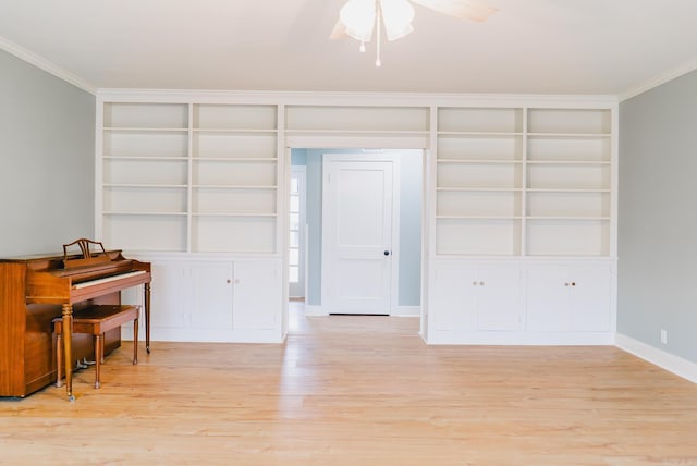 interior space featuring built in shelves, ceiling fan, light hardwood / wood-style floors, and ornamental molding