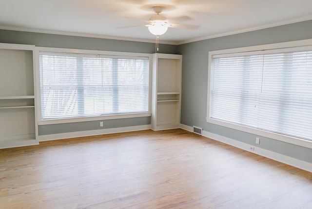 spare room with plenty of natural light, crown molding, and ceiling fan