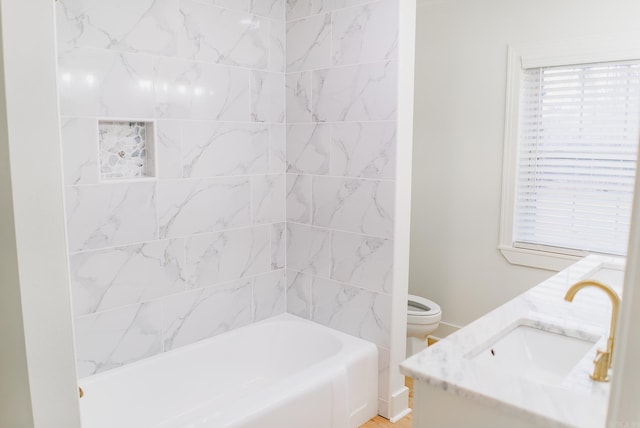 full bathroom with vanity, toilet, and tiled shower / bath