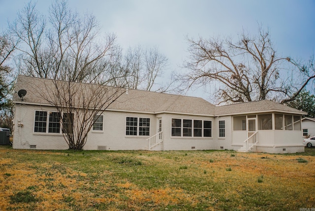 back of house with a sunroom, a yard, and central air condition unit