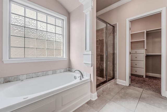 bathroom with tile patterned floors, vaulted ceiling, decorative columns, and shower with separate bathtub