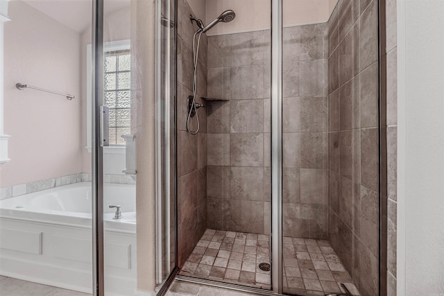 bathroom featuring separate shower and tub