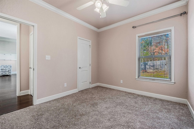 unfurnished bedroom featuring crown molding, ceiling fan, and dark colored carpet