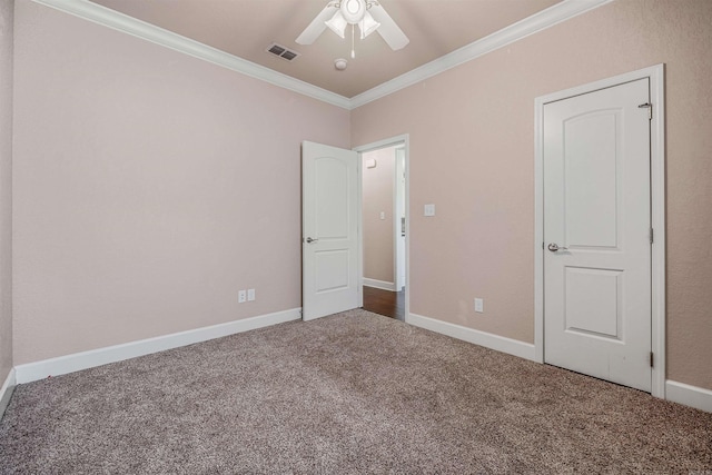 unfurnished bedroom featuring crown molding, ceiling fan, and carpet