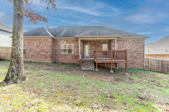 rear view of property featuring a deck