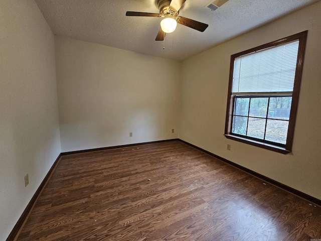 spare room with ceiling fan, dark hardwood / wood-style flooring, and a textured ceiling