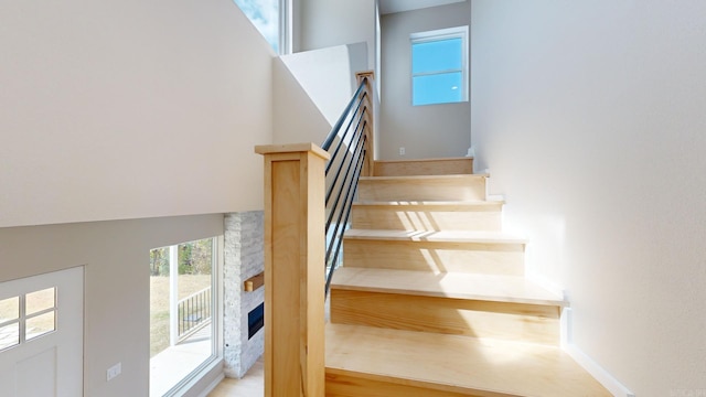 stairway featuring a fireplace