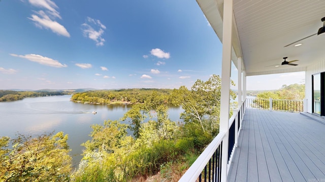 wooden terrace with a water view and ceiling fan