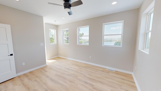 spare room featuring ceiling fan and light wood-type flooring