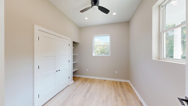 unfurnished bedroom with multiple windows, ceiling fan, and light wood-type flooring