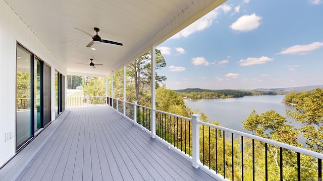 wooden deck with ceiling fan and a water view