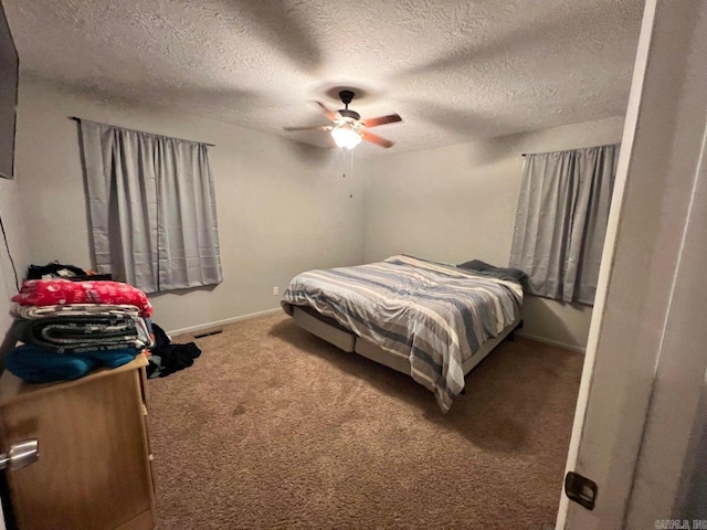 bedroom featuring carpet, ceiling fan, and a textured ceiling