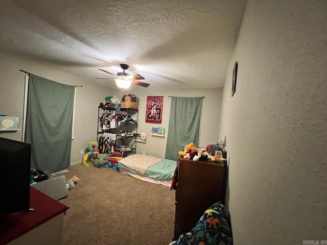 bedroom with carpet, a textured ceiling, and ceiling fan