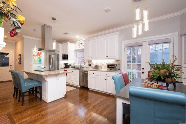 kitchen with a center island, island exhaust hood, white cabinetry, and appliances with stainless steel finishes