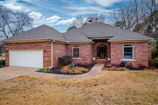 view of front of house with a front yard and a garage