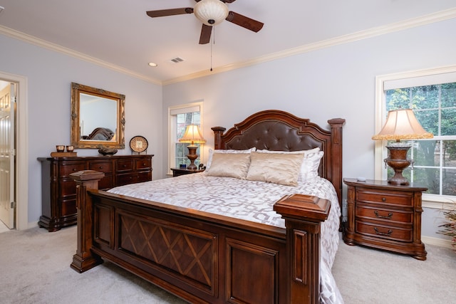 bedroom with ceiling fan, light colored carpet, and crown molding