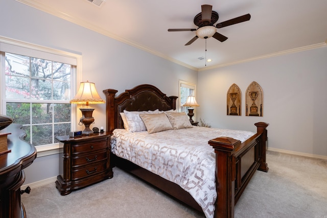 bedroom featuring crown molding, light colored carpet, and ceiling fan