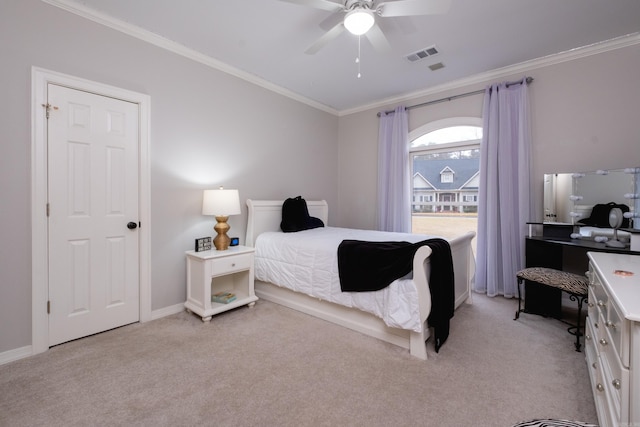 bedroom with ornamental molding, ceiling fan, and light colored carpet