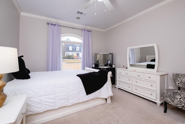 bedroom with ceiling fan, ornamental molding, and light carpet