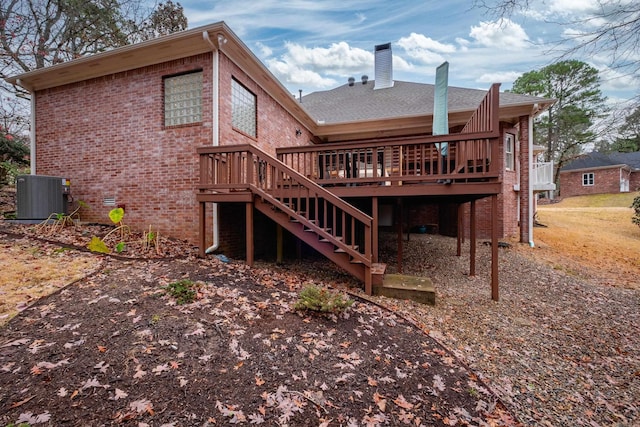 back of house featuring central air condition unit and a deck