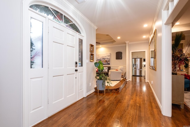 foyer entrance with crown molding and hardwood / wood-style floors