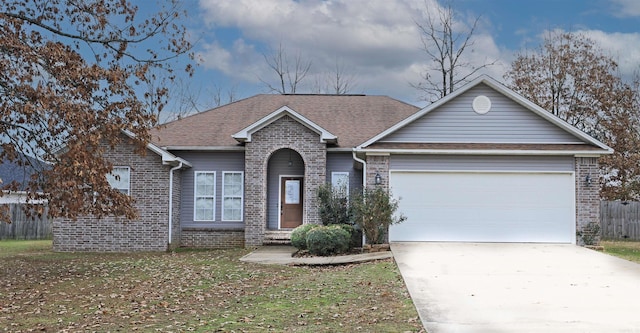 view of front of property with a front yard and a garage