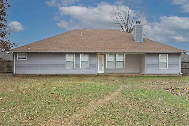 rear view of property with a yard