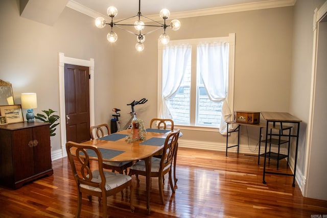 dining space with ornamental molding, dark wood-type flooring, and an inviting chandelier