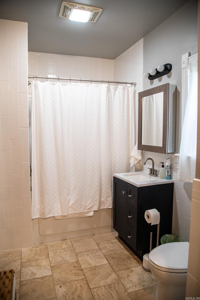 full bathroom with shower / tub combo, vanity, and toilet